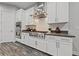 Gourmet kitchen featuring stainless appliances, gas range and stylish white cabinets and backsplash at 845 Loch Katrine Ave, Henderson, NV 89012