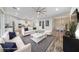 Spacious, bright living room with neutral walls, ceiling fan, access to the kitchen and dining room at 845 Loch Katrine Ave, Henderson, NV 89012