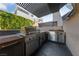 Outdoor kitchen with stainless steel appliances, a built-in grill, and ample counter space at 845 Loch Katrine Ave, Henderson, NV 89012