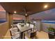 Covered patio featuring an outdoor dining area with city views provides a stylish entertaining space at 845 Loch Katrine Ave, Henderson, NV 89012