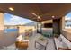 Relaxing outdoor patio with fireplace, television, fan, and comfortable seating with scenic mountain views at 845 Loch Katrine Ave, Henderson, NV 89012