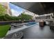 Beautiful backyard with a refreshing pool, outdoor kitchen, fire pit, lounge chairs, and lush landscaping at 845 Loch Katrine Ave, Henderson, NV 89012