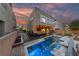Backyard with a modern pool, lounge chairs, and a covered patio for ultimate outdoor living at 845 Loch Katrine Ave, Henderson, NV 89012