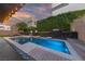 Backyard with a modern pool, lounge chairs, and a covered patio for ultimate outdoor living at 845 Loch Katrine Ave, Henderson, NV 89012