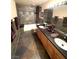 Bathroom with double sink vanity, granite countertop, and a tiled shower and tub combination at 8690 W Ford Ave, Las Vegas, NV 89148