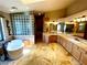 Bright bathroom featuring a modern soaking tub, glass block shower, and spacious countertops at 8690 W Ford Ave, Las Vegas, NV 89148