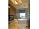 Modern bathroom featuring a soaking tub near a fireplace and a glass block window at 8690 W Ford Ave, Las Vegas, NV 89148