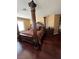 Bedroom featuring a four-post bed with dark wood floors and shutters at 8690 W Ford Ave, Las Vegas, NV 89148