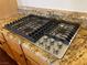 This kitchen features a KitchenAid cooktop with a granite countertop at 8690 W Ford Ave, Las Vegas, NV 89148