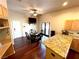 Cozy dining area with a round table, four chairs, and a ceiling fan, located adjacent to the kitchen at 8690 W Ford Ave, Las Vegas, NV 89148
