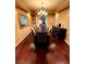 Formal dining room with a long wood table, decorative chandelier, and a dark wood credenza at 8690 W Ford Ave, Las Vegas, NV 89148