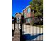 Gated driveway and brick front featuring a lamp post and manicured landscaping at 8690 W Ford Ave, Las Vegas, NV 89148