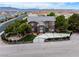 Elegant brick home with a gated entrance, landscaped yard, and water feature at 8690 W Ford Ave, Las Vegas, NV 89148