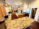 Spacious kitchen with granite countertops, stainless steel appliances, and a central island with wooden floor at 8690 W Ford Ave, Las Vegas, NV 89148