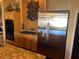 Kitchen with stainless steel refrigerator, double oven, gas cooktop, and granite countertops at 8690 W Ford Ave, Las Vegas, NV 89148