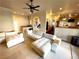 Airy living room featuring neutral tones, modern furnishings, and a seamless flow to the kitchen area at 8690 W Ford Ave, Las Vegas, NV 89148