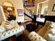 Comfortable living room with plush sofas, decorative rug, and views of the dining area and staircase at 8690 W Ford Ave, Las Vegas, NV 89148