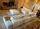 Cozy living room featuring a modern sectional sofa, fireplace, and tiled flooring at 8690 W Ford Ave, Las Vegas, NV 89148
