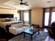 Spacious main bedroom features a bed, couch, and multiple windows with curtains at 8690 W Ford Ave, Las Vegas, NV 89148