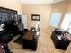 Spacious office features a large dark wood desk, shelving and a comfortable leather chair at 8690 W Ford Ave, Las Vegas, NV 89148