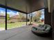 Covered patio with outdoor seating and a view of the green backyard at 8690 W Ford Ave, Las Vegas, NV 89148