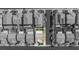 Areal view of a neighborhood, showing many rooftops and suburban area in grayscale with one yard highlighted at 9113 Sea Mink Ave, Las Vegas, NV 89149