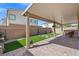 Backyard with artificial grass, a covered patio, and potted plants at 9113 Sea Mink Ave, Las Vegas, NV 89149