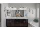 Well-lit bathroom featuring double sinks, vanity, and a soaking tub for relaxation at 9113 Sea Mink Ave, Las Vegas, NV 89149
