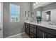 Bright bathroom featuring dual sinks, ample counter space and a window providing natural light at 9113 Sea Mink Ave, Las Vegas, NV 89149
