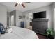 Bedroom with wood floors, ceiling fan, neutral walls, dresser, and white comforter at 9113 Sea Mink Ave, Las Vegas, NV 89149