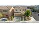 Home's exterior featuring a two-car garage and desert landscaping at 9113 Sea Mink Ave, Las Vegas, NV 89149