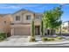Inviting two-story home with a neutral exterior, mature landscaping, and a spacious two-car garage at 9113 Sea Mink Ave, Las Vegas, NV 89149