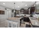 Modern kitchen with granite countertops, stainless appliances, and island seating at 9113 Sea Mink Ave, Las Vegas, NV 89149