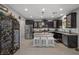 Modern kitchen with stainless steel appliances, granite counters, and a wine rack at 9113 Sea Mink Ave, Las Vegas, NV 89149