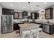Modern kitchen with granite countertops, stainless steel appliances, and a central island with seating at 9113 Sea Mink Ave, Las Vegas, NV 89149