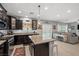 Open kitchen with granite countertops, stainless appliances, and a center island flows into the living area at 9113 Sea Mink Ave, Las Vegas, NV 89149