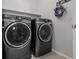 Laundry room featuring gray front load washer and dryer at 9113 Sea Mink Ave, Las Vegas, NV 89149