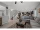 Spacious living room with tiled flooring, staircase, and kitchen access at 9113 Sea Mink Ave, Las Vegas, NV 89149