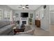 Cozy living room featuring a fireplace, ceiling fan, and large windows at 9113 Sea Mink Ave, Las Vegas, NV 89149