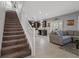 Carpeted staircase leading to an open living room and kitchen at 9113 Sea Mink Ave, Las Vegas, NV 89149