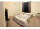 Neutral bedroom with a large closet, minimalist furnishings, and cozy bedding at 10077 Cooper Mountain St, Las Vegas, NV 89141