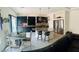 Spacious kitchen featuring dark cabinetry, stainless appliances, large island and a dining area at 10077 Cooper Mountain St, Las Vegas, NV 89141