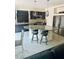 Stylish kitchen featuring dark cabinets, granite countertops, and stainless steel appliances at 10077 Cooper Mountain St, Las Vegas, NV 89141