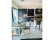 Modern kitchen with dark cabinets, stainless steel appliances, and a breakfast bar at 10077 Cooper Mountain St, Las Vegas, NV 89141