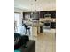 Open kitchen with a large island, dark cabinetry, and stainless steel appliances at 10077 Cooper Mountain St, Las Vegas, NV 89141