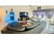 Comfortable living room with a large sectional sofa, TV, and modern decor at 10077 Cooper Mountain St, Las Vegas, NV 89141