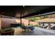 Covered patio with barbecue, dining table, and a barrel fire pit, perfect for outdoor gatherings at 10666 Cherry Ridge Ct, Las Vegas, NV 89129