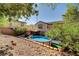 Spacious backyard showcasing a pool, patio, and low-maintenance desert landscaping at 10666 Cherry Ridge Ct, Las Vegas, NV 89129