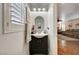 Stylish powder room with modern vanity, oval mirror and decorative wall art at 10666 Cherry Ridge Ct, Las Vegas, NV 89129