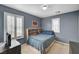Comfortable bedroom showcasing blue walls, natural light, and a built-in headboard with storage at 10666 Cherry Ridge Ct, Las Vegas, NV 89129